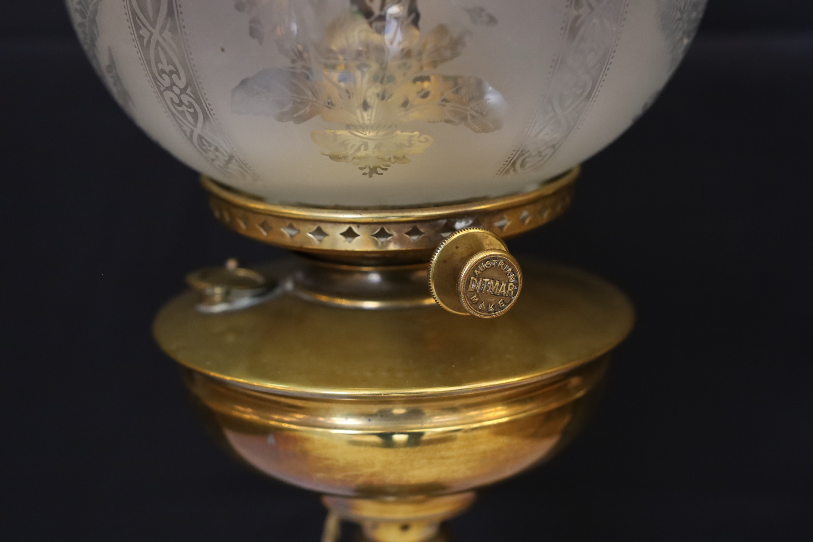 A late 19 century Austrian brass oil lamp with Ditmar mechanism and etched glass shade, converted to electricity, height overall 78cm